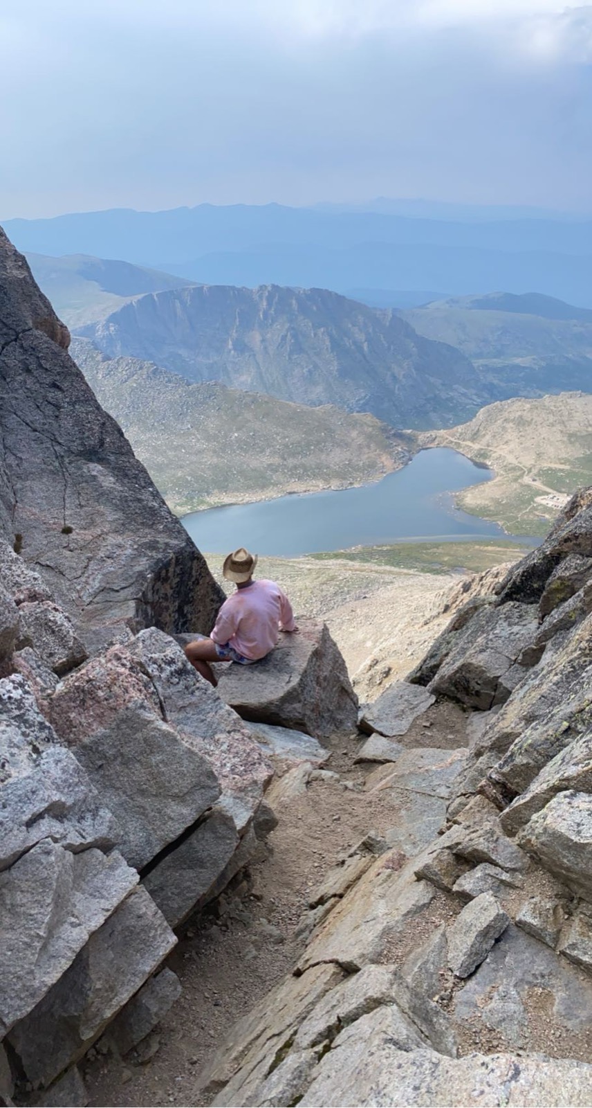 Brent on a Colorado summit overlooking an alpine lake